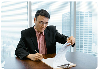 A professional reviewing and signing important building certification documents